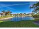 Beautiful community pond surrounded by lush landscaping and well-maintained homes at 409 Pine Hollow Cir # 409, Englewood, FL 34223