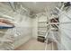 Spacious walk-in closet with shelving, providing ample storage space for clothes and accessories at 409 Pine Hollow Cir # 409, Englewood, FL 34223