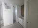 Bright bathroom with a shower stall, a wood accent wall, and a vanity with white cabinets at 418 Rotonda Cir, Rotonda West, FL 33947