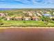 Aerial view of waterfront homes showing tile roofs and lush landscaping with lake in background at 4624 Club Dr # G201, Port Charlotte, FL 33953