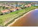 Scenic aerial showcasing waterfront homes, lush landscaping, and serene lake views at 4624 Club Dr # G201, Port Charlotte, FL 33953