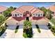 Stunning aerial view of the Mediterranean-style home showcasing the red tile roof and lush landscaping near the water at 4624 Club Dr # G201, Port Charlotte, FL 33953
