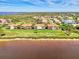 Aerial view of waterfront homes showing tile roofs and lush landscaping with lake in background at 4624 Club Dr # G201, Port Charlotte, FL 33953