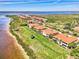 Aerial view of waterfront homes showing tile roofs and lush landscaping and water views at 4624 Club Dr # G201, Port Charlotte, FL 33953