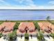 Waterfront property with vibrant landscaping and terracotta roofing at 4624 Club Dr # G201, Port Charlotte, FL 33953