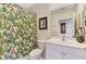 Bathroom featuring a single sink vanity, tropical patterned shower curtain, mirror, and toilet at 4624 Club Dr # G201, Port Charlotte, FL 33953