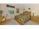 Bedroom showcasing a wooden bed frame, window, side tables, and desk with chair at 4624 Club Dr # G201, Port Charlotte, FL 33953