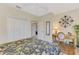 Bedroom featuring a desk and chair, closet with bi-fold doors, and a door leading to another part of the home at 4624 Club Dr # G201, Port Charlotte, FL 33953