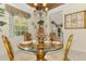 Bright dining room with a tropical style, a glass table setting, and natural lighting at 4624 Club Dr # G201, Port Charlotte, FL 33953