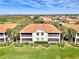 Beautiful home with a red tile roof, screened in porches and stunning landscaping at 4624 Club Dr # G201, Port Charlotte, FL 33953