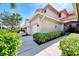 Side view of the home's exterior featuring a well-manicured lawn, shrubbery, and clean sidewalk at 4624 Club Dr # G201, Port Charlotte, FL 33953