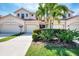 Inviting exterior showcasing the home's well-maintained landscaping, cream-colored stucco, and attached two-car garage at 4624 Club Dr # G201, Port Charlotte, FL 33953