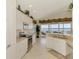 Modern kitchen with white cabinets, granite counters, stainless appliances, and water view at 4624 Club Dr # G201, Port Charlotte, FL 33953
