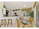 Eat-in kitchen featuring white cabinets, granite counters, stainless appliances, and tile floors at 4624 Club Dr # G201, Port Charlotte, FL 33953