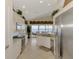 Modern white kitchen with granite counters, stainless appliances, and lovely water views at 4624 Club Dr # G201, Port Charlotte, FL 33953