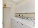 Efficient laundry room featuring front load washer and dryer with overhead cabinets and wire shelving at 4624 Club Dr # G201, Port Charlotte, FL 33953