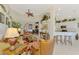 Bright living room with plants, ceiling fan, open floor plan, tile floors and eclectic decor at 4624 Club Dr # G201, Port Charlotte, FL 33953