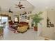 Comfortable living room featuring a ceiling fan, plush seating, and sliding glass doors for natural light at 4624 Club Dr # G201, Port Charlotte, FL 33953