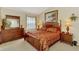 Bedroom with furnishings, a dresser, and large windows offering views of the serene waterfront at 4624 Club Dr # G201, Port Charlotte, FL 33953