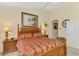Cozy main bedroom featuring a wood bed frame, side tables and an archway leading to other parts of the home at 4624 Club Dr # G201, Port Charlotte, FL 33953