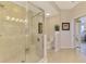 Bright bathroom featuring a tiled shower with seamless glass doors and neutral tile flooring at 4697 Club Dr # 201, Port Charlotte, FL 33953