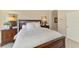 Cozy bedroom with a plush bed and a classic wood dresser at 4697 Club Dr # 201, Port Charlotte, FL 33953