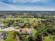Expansive aerial view of property showcasing a beautiful pool and lush green landscaping at 48 Par View Ct, Rotonda West, FL 33947
