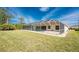 Manicured lawn and screened-in pool enclosure, creating a private oasis for relaxation and recreation at 48 Par View Ct, Rotonda West, FL 33947