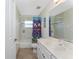 Bathroom with a bathtub, shower with a colorful curtain, and a vanity with a large mirror at 48 Par View Ct, Rotonda West, FL 33947