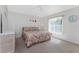 Cozy bedroom with a ceiling fan, a large window for natural light, and neutral carpet at 48 Par View Ct, Rotonda West, FL 33947