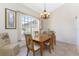 Charming dining room featuring a wooden table set, large window, and decorative chandelier at 48 Par View Ct, Rotonda West, FL 33947