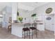 Bright and open kitchen with white cabinetry, breakfast bar, and high ceilings at 48 Par View Ct, Rotonda West, FL 33947