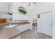 Well-lit kitchen featuring white cabinetry, tile floors, and an open layout at 48 Par View Ct, Rotonda West, FL 33947