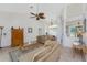 Elegant living room with high ceilings, neutral tones, and a ceiling fan with leaf-shaped blades at 48 Par View Ct, Rotonda West, FL 33947