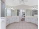 This is a shared bathroom featuring a walk-in shower, double vanity, and entrance to the main bedroom at 48 Par View Ct, Rotonda West, FL 33947
