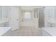 Bright bathroom with a walk-in shower, bathtub, and double sink with plenty of natural light at 48 Par View Ct, Rotonda West, FL 33947