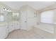 This main bathroom features a large vanity, a soaking tub, tile flooring, and lots of natural light at 48 Par View Ct, Rotonda West, FL 33947