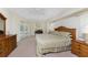 Bright main bedroom featuring a ceiling fan, ensuite with double doors, and a spacious carpeted floor at 48 Par View Ct, Rotonda West, FL 33947