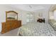 Sunlit main bedroom offers neutral carpet and light-filled windows, alongside beautiful furnishings and decor at 48 Par View Ct, Rotonda West, FL 33947