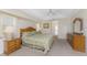 The main bedroom has ample space with light-colored carpet, a ceiling fan, and great natural light at 48 Par View Ct, Rotonda West, FL 33947