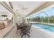 Screened patio with a dining table and chairs next to the pool overlooking the backyard at 48 Par View Ct, Rotonda West, FL 33947