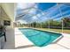 Relaxing screened-in pool area with clear blue water and an open view of the backyard at 48 Par View Ct, Rotonda West, FL 33947