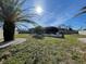 Backyard features a screened enclosure, manicured lawn, and perimeter landscaping with a privacy fence at 5262 Weatherton St, North Port, FL 34288