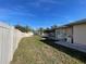 Expansive backyard featuring a screened-in pool, a privacy fence and a home generator on the side of the house at 5262 Weatherton St, North Port, FL 34288