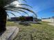 Backyard features a screened enclosure, manicured lawn, and perimeter landscaping with a privacy fence at 5262 Weatherton St, North Port, FL 34288
