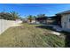 Large grassy backyard with a screened in pool and a sturdy privacy fence, perfect for outdoor enjoyment at 5262 Weatherton St, North Port, FL 34288