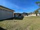 Spacious backyard features a screened enclosure, manicured lawn, and beige exterior walls at 5262 Weatherton St, North Port, FL 34288