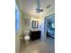 Bright bathroom features a single vanity, toilet, and flamingo-themed wall art at 5262 Weatherton St, North Port, FL 34288