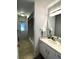 Hall bathroom boasts shower-tub combo, and white vanity with generous counter space at 5262 Weatherton St, North Port, FL 34288