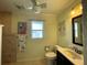 Bathroom showcasing flamingo artwork, tile floors, and a vanity with mirror and sink at 5262 Weatherton St, North Port, FL 34288